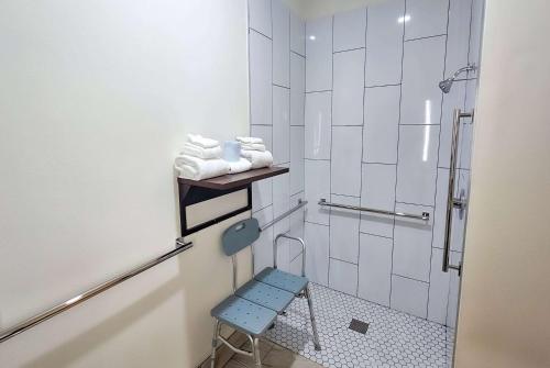 a bathroom with a blue stool in a shower at La Quinta by Wyndham Dallas Mesquite in Mesquite