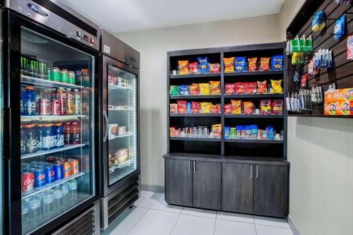 a grocery store aisle with a refrigerator and drinks at La Quinta by Wyndham Dallas Mesquite in Mesquite