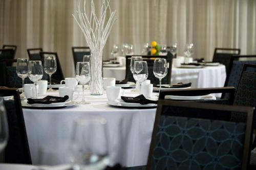 a table with wine glasses and plates on it at Cambria Hotel Phoenix Chandler - Fashion Center in Chandler