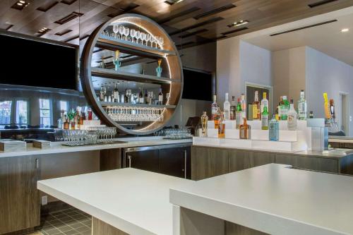 a bar with a lot of bottles of alcohol at Cambria Hotel Phoenix Chandler - Fashion Center in Chandler