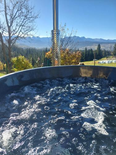 a hot tub filled with lots of water at Panoramiczny Wierch in Rzepiska