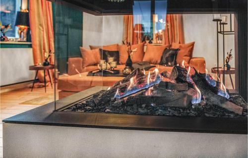 a fireplace in a living room with a couch at 3 Bedroom Beautiful Home In Wartenberg in Landenhausen