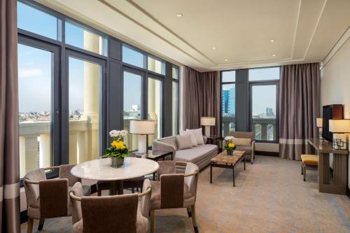 a living room with a couch and a table at The Hotel Galleria Jeddah, Curio Collection by Hilton in Jeddah