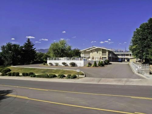a road in front of a house with a driveway at Motel 6 Colorado Springs, CO – South/Metro Area in Colorado Springs