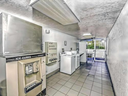 a kitchen with a stove and appliances in it at Motel 6 Colorado Springs, CO – South/Metro Area in Colorado Springs