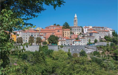 a town on a hill with a castle at Stunning Apartment In Labin With House Sea View in Labin