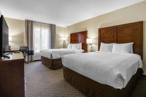 a hotel room with two beds and a television at Comfort Inn & Suites Logan Near University in Logan