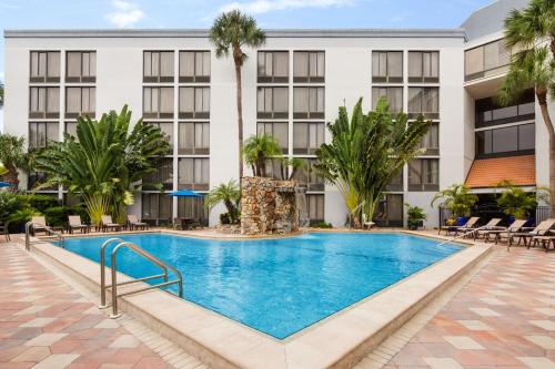 a swimming pool in front of a hotel at Doubletree by Hilton Fort Myers at Bell Tower Shops in Fort Myers