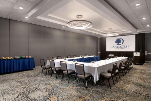 a conference room with a long table and chairs at Doubletree by Hilton Fort Myers at Bell Tower Shops in Fort Myers