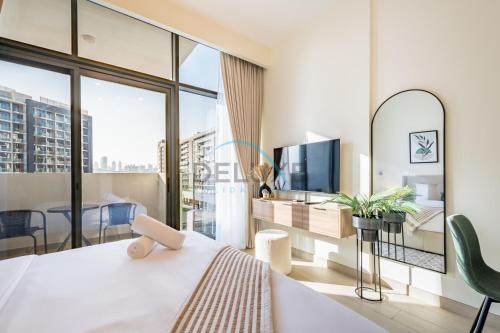 a bedroom with a bed and a large window at Calming Studio Apartment at Azizi Riviera 4, Al Merkadh by Deluxe Holiday Homes in Dubai