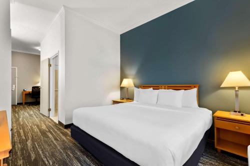 a large white bed in a hotel room at Clarion Suites Anchorage Downtown in Anchorage