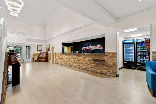 a lobby with a fish tank on a brick wall at Clarion Suites Anchorage Downtown in Anchorage