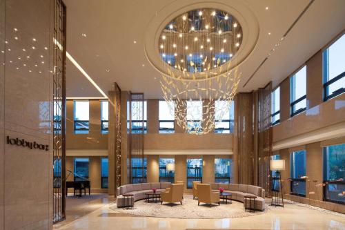 a large lobby with a chandelier in a building at Ramada Jinan in Jinan