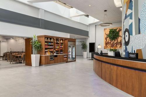 a lobby with a bar and a dining area at Doubletree by Hilton Fort Myers at Bell Tower Shops in Fort Myers