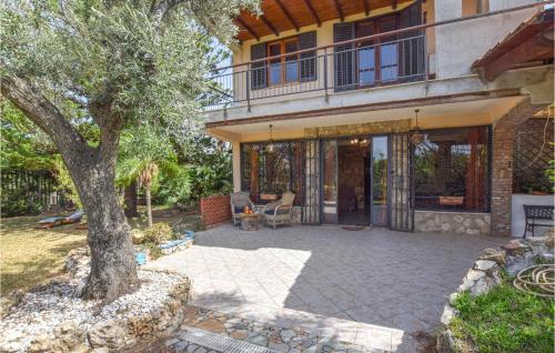 a house with a patio with a tree in front of it at 3 Bedroom Lovely Home In Borgetto in Borgetto
