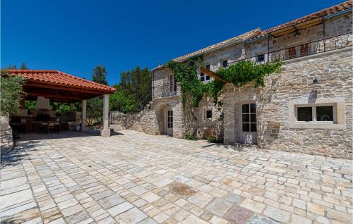 a stone building with a patio in front of it at 2 Bedroom Lovely Home In Blato in Blato