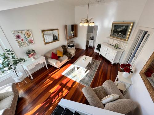 a living room with a couch and a table at La Casa Bonita Auckland in Auckland