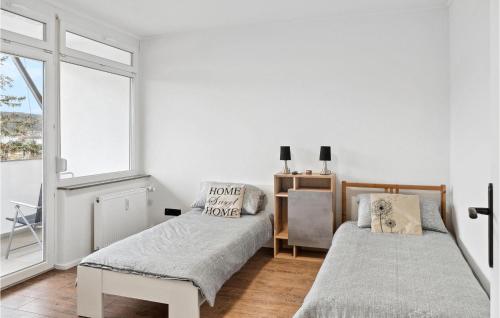 a bedroom with two beds and a window at Nice Apartment In Tauberbischofsheim in Tauberbischofsheim