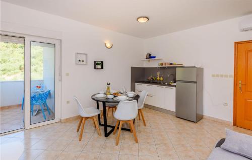 a kitchen and dining room with a table and chairs at Awesome Apartment In Klek With Wi-Fi in Klek