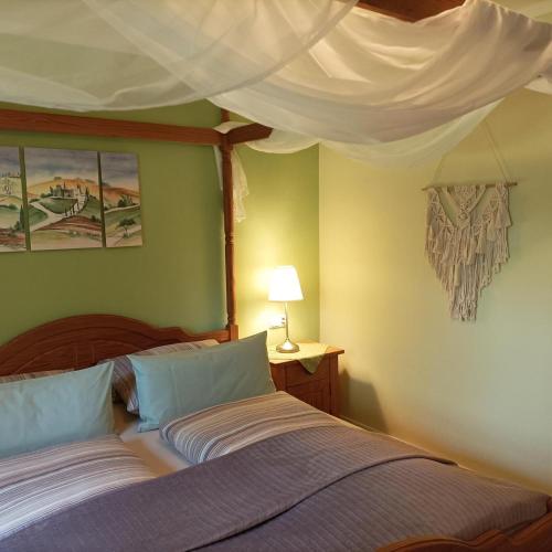 a bedroom with two beds and a canopy at Ferienwohnung Ilona, Armin & Simon Funke in Halblech