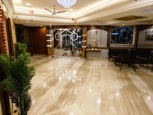 a large room with a wooden floor and tables and chairs at Chandra Inn in Jodhpur