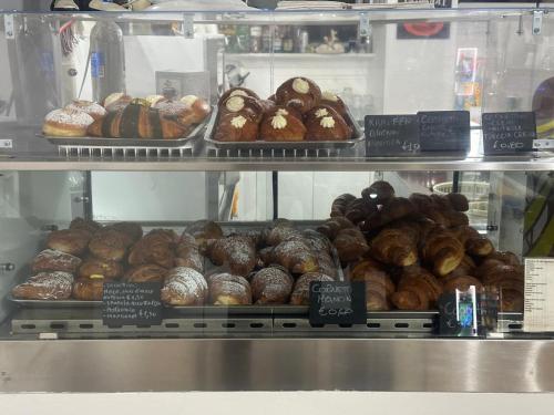 a display case with lots of different types of donuts at Exclusive B&B in Reggio Calabria