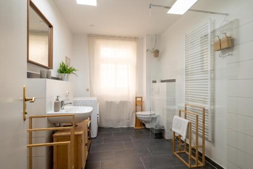 a bathroom with a sink and a toilet at Leipzig Mitte - 2 Parkplätze - Koselig Apartments in Leipzig