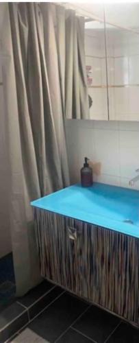 a bathroom with a blue counter and a mirror at Seasmiles in Akrata