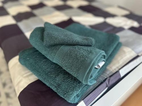 two green towels sitting on top of a table at Ferien- Monteurwohnung in Förderstedt, Staßfurt in Staßfurt