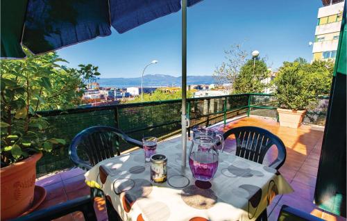a table on a balcony with a view of a city at Beautiful Apartment In Rijeka With Wifi in Rijeka