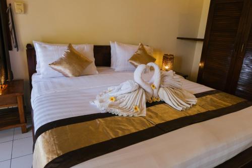Katil atau katil-katil dalam bilik di New Starlight Hotel Lovina