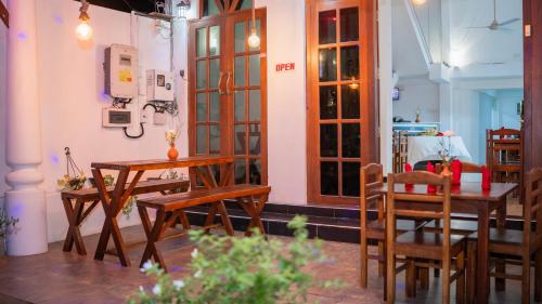 a dining room with wooden tables and chairs at Yash Rest Inn in Negombo