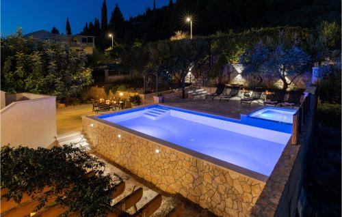 a swimming pool in a backyard at night at Apartment Blace With Sea View Xii in Blace