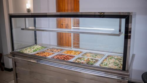 a display case filled with different types of food at Yash Rest Inn in Negombo