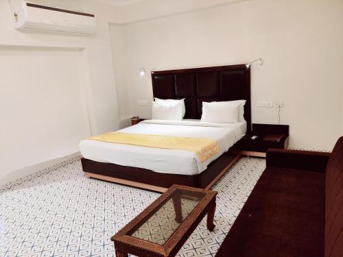 a bedroom with a large bed in a room at Chandra Inn in Jodhpur
