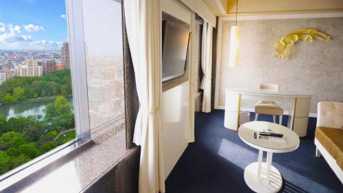 a room with a view of a city from a window at Premier Hotel Nakajima Park Sapporo in Sapporo