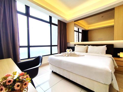 a hotel room with a large bed and a window at Genting SkyCozyColdInn2R2B AT Ion Delemen in Genting Highlands