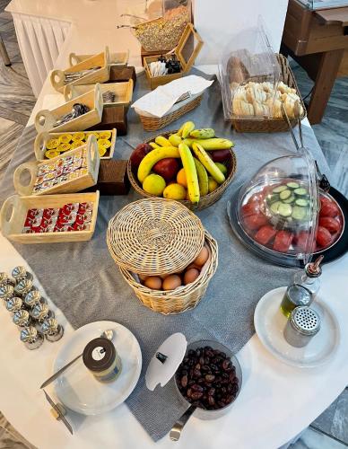 a table topped with baskets of fruit and other food at Pal Beach in Palaiochóra