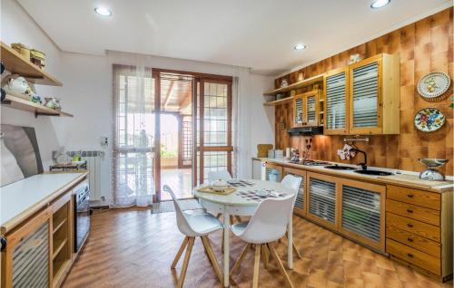 a kitchen with a table and chairs in a room at Gorgeous Home In Comiso With Wifi in Comiso