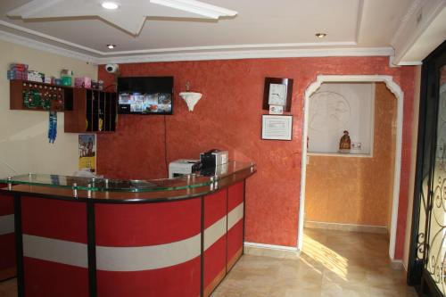 a red and white bar in a restaurant with a counter at Hotel El Parque HR in Fómeque