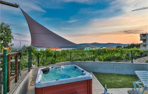 a hot tub on the balcony of a house at Awesome Home In Seget Donji in Seget Donji