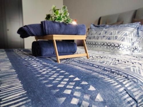 a pile of blue pillows on a bed at Continew Residence by HomeBrickz in Kuala Lumpur