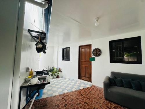 a living room with a couch and a table and a door at Rivero Transient House in San Fernando
