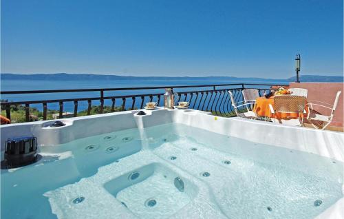 a hot tub sitting on top of a balcony at Holiday Home Gornji Tucepi-Srida Sela Bb Ii in Tučepi