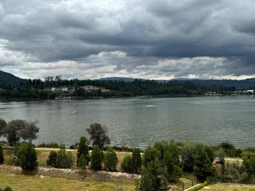 a view of a river with a boat in the water at Náutica Lake Paipa - Penthouse in Paipa