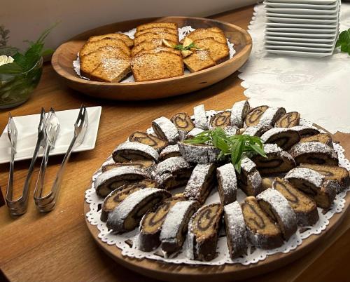 a table with a plate of sushi and a plate of bread at Old Parish House in Bled