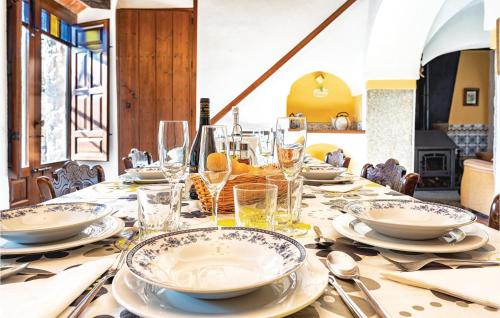 a dining table with plates and glasses on it at Amazing Home In Añora With Wifi in Anora
