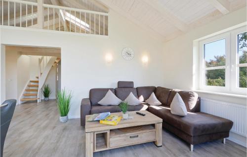 a living room with a couch and a table at Stunning Home In Dagebüll With Wifi in Dagebüll