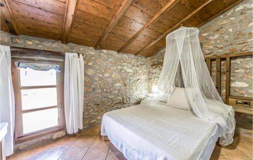 a bedroom with a bed with a canopy at Stunning Home In Les Coves De Vinromá in Les Coves de Vinroma