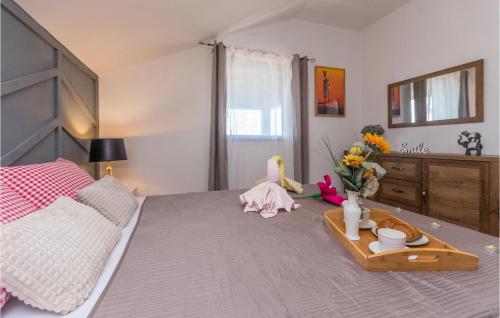 a bedroom with a bed with a tray with flowers on it at Pet Friendly Home In Tinj With Jacuzzi in Tinj